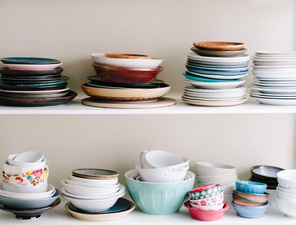 open shelves colorful plates bowls stacked