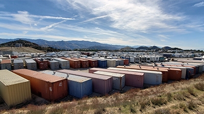 multiple color shipping containers stored on a large lot