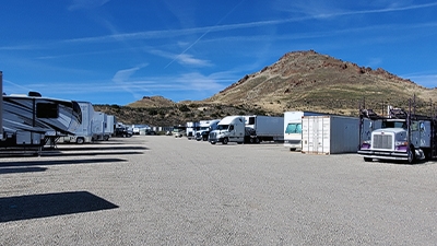 RVs 18 wheelers and shipping containers on a lot