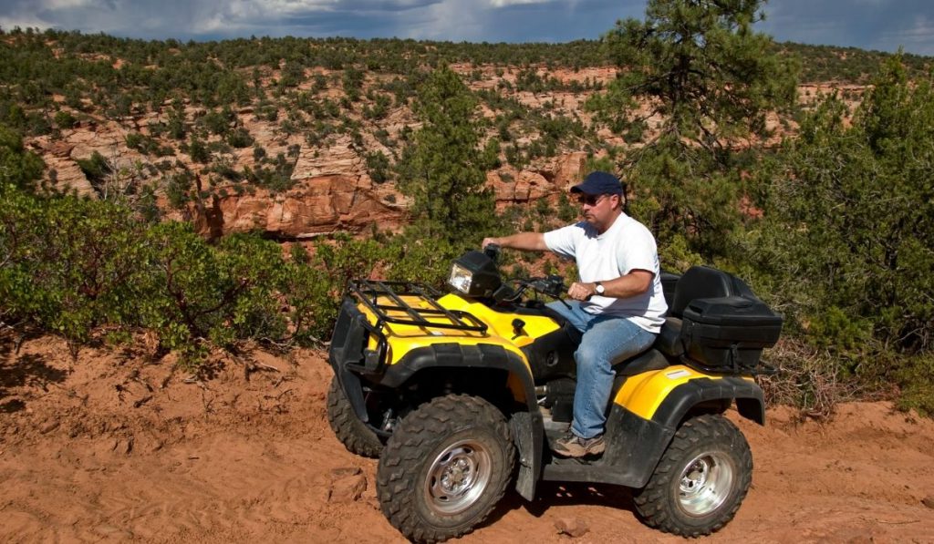 man on ATV exploring the summit