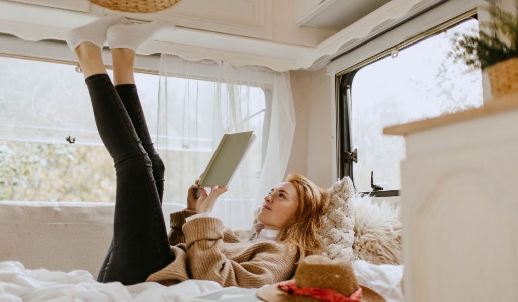 woman lying down with feet up in an RV